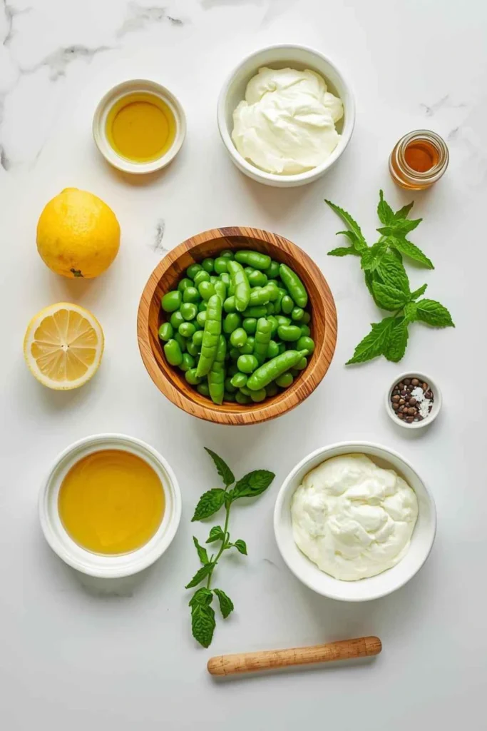 The Best Whipped Ricotta Recipe (Spring Pea & Mint Salad in 15 Minutes!) 3 Ingredients for whipped ricotta recipe with spring peas and mint on white marble — ricotta, peas, lemon, olive oil, mint