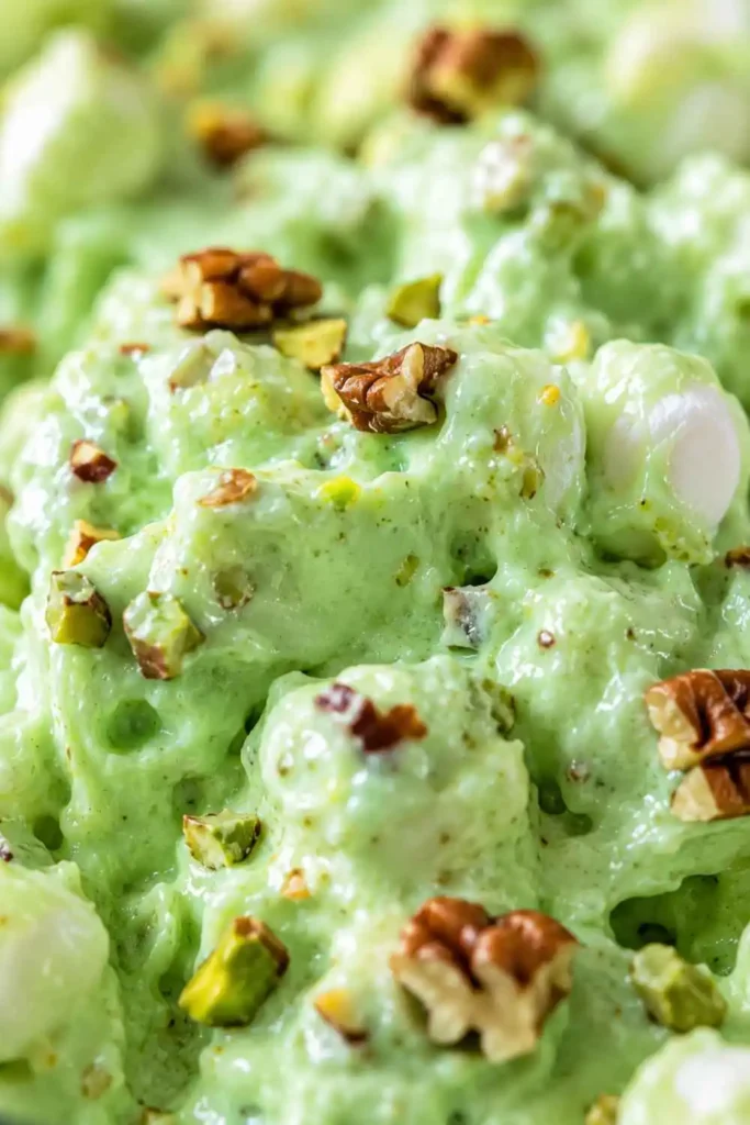 Close-up of creamy pistachio fluff texture with marshmallows in Watergate salad recipe